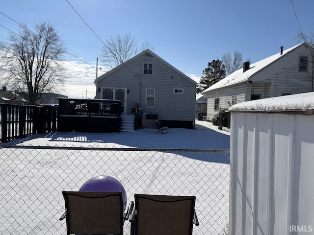 snow covered pool with a wooden deck