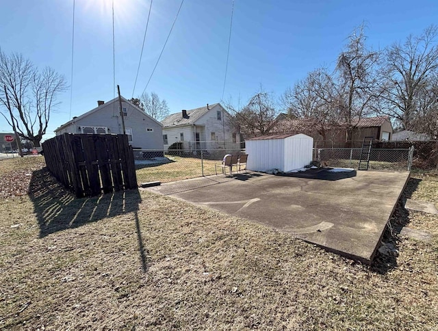 view of yard featuring a storage shed and a patio