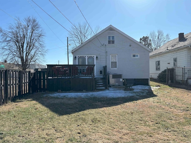 back of property with cooling unit, a lawn, and a deck