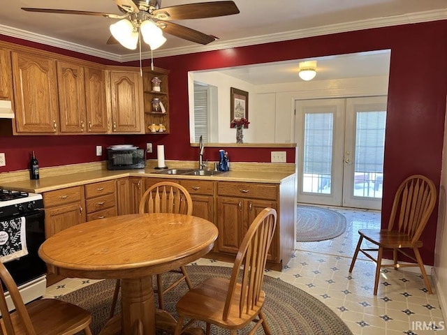 kitchen featuring sink, crown molding, range hood, gas range, and french doors