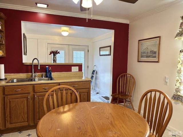 kitchen featuring crown molding, sink, and ceiling fan