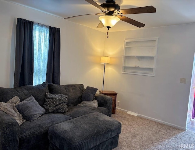 carpeted living room featuring ceiling fan