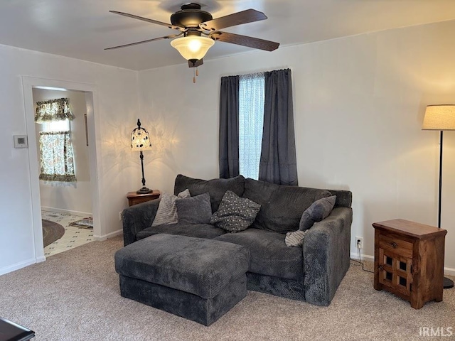 living room featuring ceiling fan, plenty of natural light, and carpet