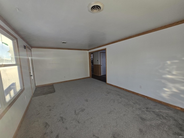 spare room with ornamental molding and light carpet