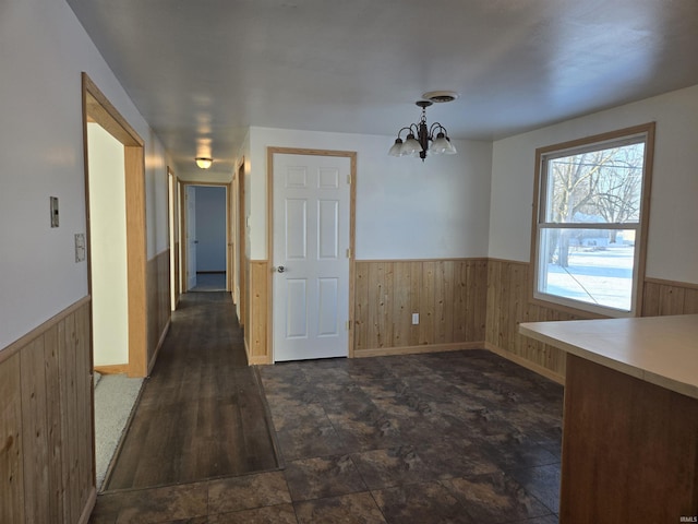 unfurnished dining area with an inviting chandelier