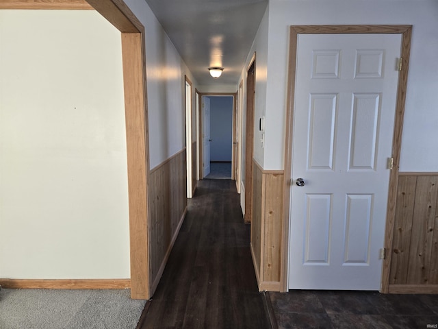 hall featuring wood walls