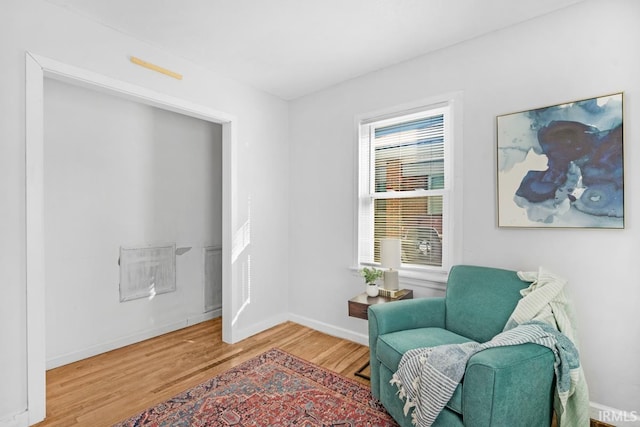 living area with hardwood / wood-style floors