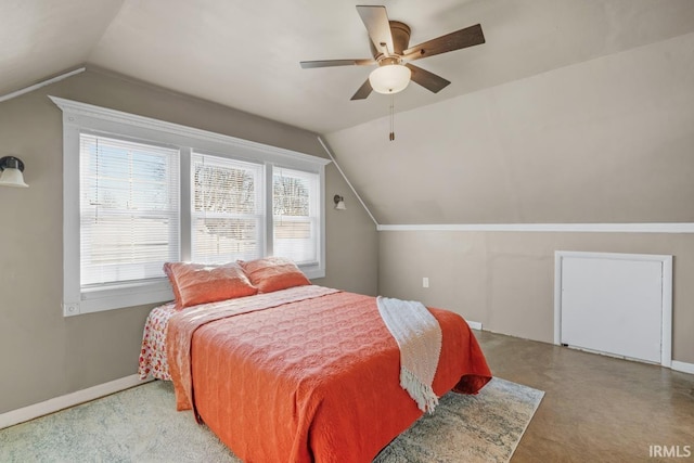 bedroom with ceiling fan, lofted ceiling, and multiple windows