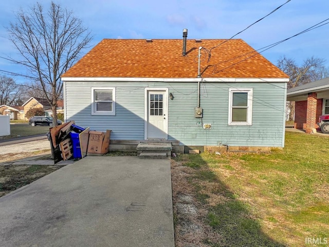 rear view of property featuring a yard