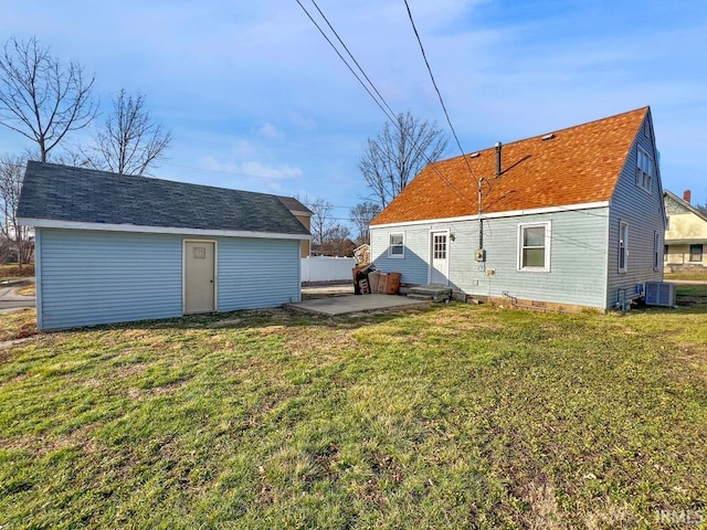 rear view of property featuring cooling unit, a patio area, and a yard