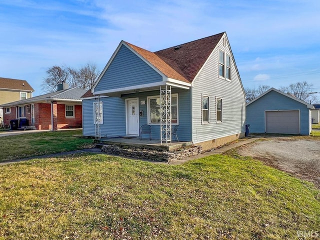 view of front of property featuring an outbuilding, covered porch, a front yard, and a garage