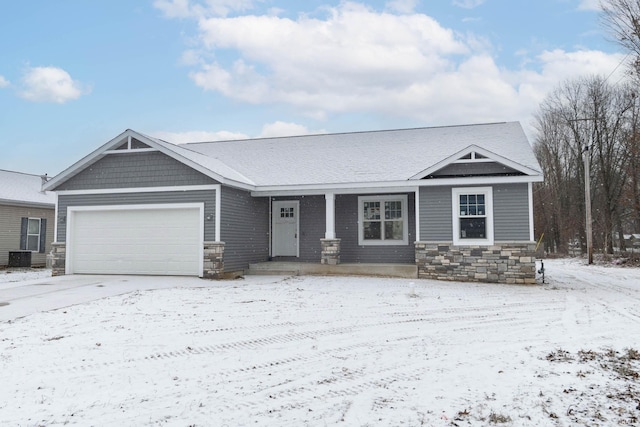 craftsman inspired home featuring cooling unit and a garage