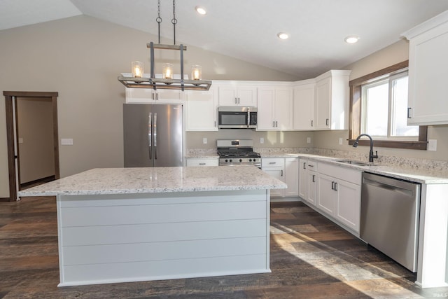 kitchen featuring pendant lighting, sink, appliances with stainless steel finishes, white cabinetry, and a kitchen island