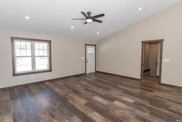 unfurnished living room with lofted ceiling, dark hardwood / wood-style flooring, and ceiling fan