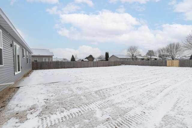 view of yard layered in snow