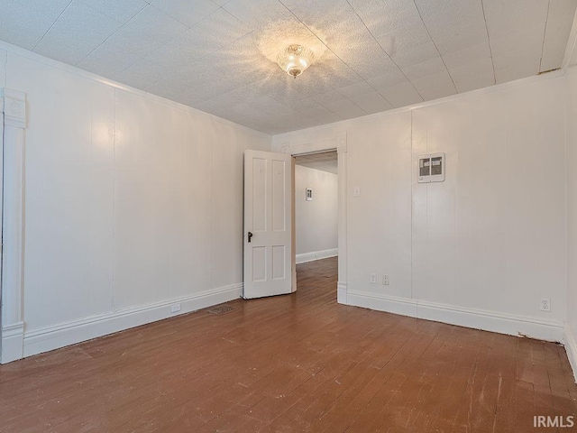 unfurnished room featuring wood-type flooring and crown molding