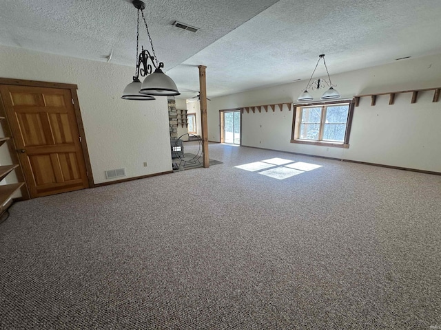 unfurnished dining area with carpet and a textured ceiling