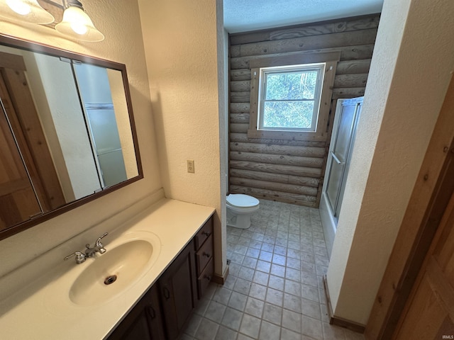 bathroom featuring walk in shower, wood walls, vanity, and toilet