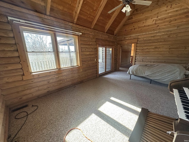 unfurnished bedroom featuring rustic walls, ceiling fan, vaulted ceiling with beams, carpet floors, and wood ceiling