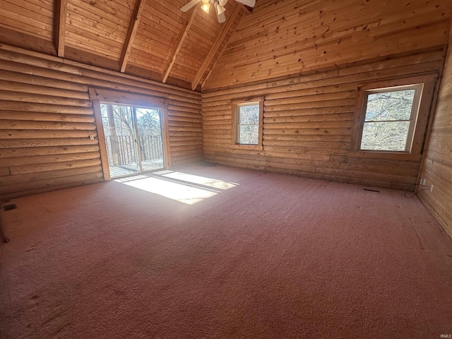 empty room with wood ceiling, ceiling fan, log walls, beam ceiling, and high vaulted ceiling