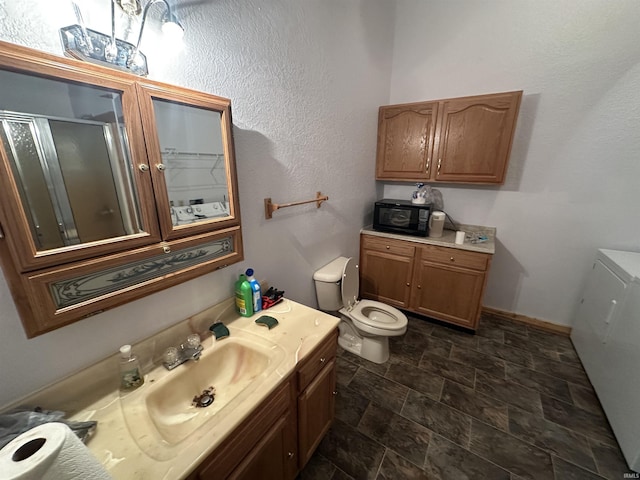 bathroom featuring vanity, toilet, and a shower with door