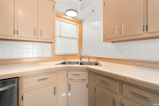 kitchen featuring backsplash, tile countertops, dishwasher, and sink