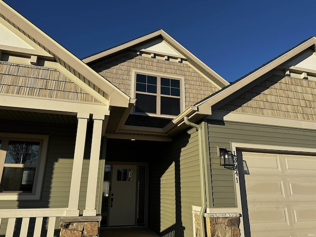 property entrance featuring a garage and a balcony