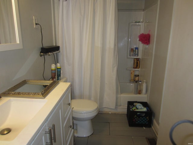 full bathroom with tile patterned floors, shower / bathtub combination with curtain, vanity, and toilet