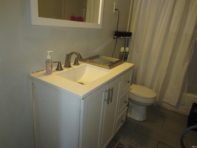 bathroom featuring tile patterned flooring, vanity, and toilet