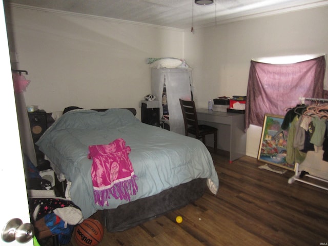 bedroom featuring dark wood-type flooring and ornamental molding