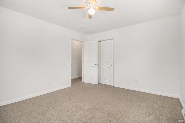 unfurnished bedroom with ceiling fan, carpet floors, and a closet