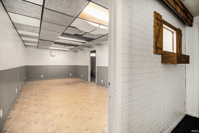 basement featuring a paneled ceiling