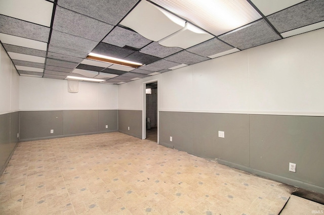 basement with a paneled ceiling