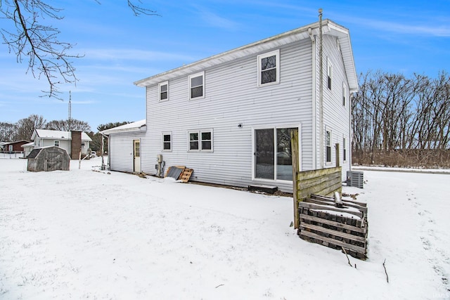 view of snow covered back of property