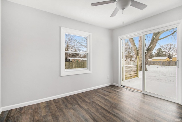 empty room featuring ceiling fan and dark hardwood / wood-style flooring