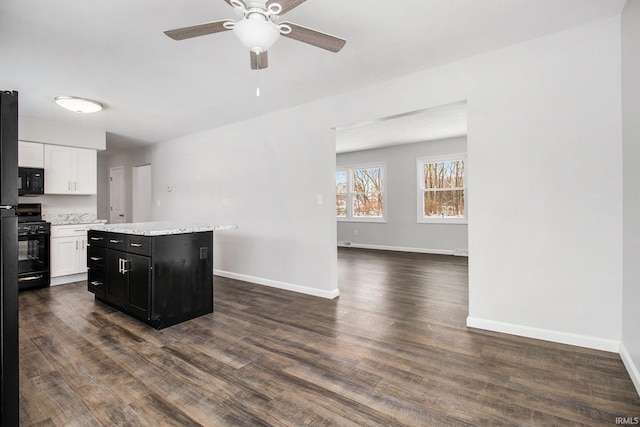 kitchen with a center island, white cabinets, black appliances, dark hardwood / wood-style floors, and ceiling fan