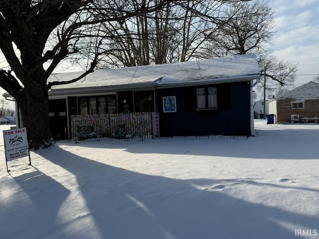 view of snow covered rear of property