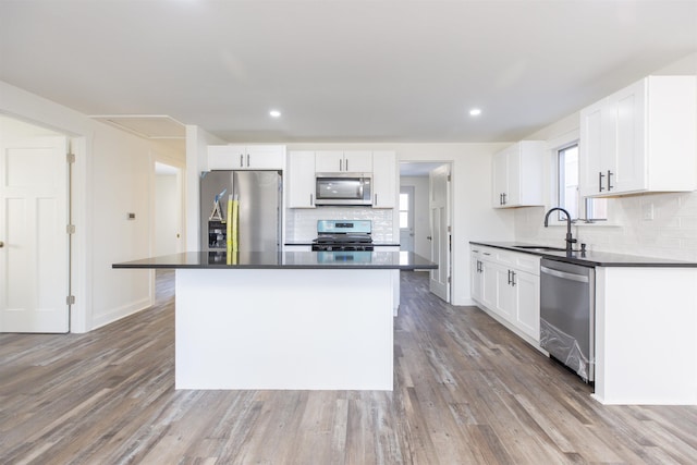 kitchen featuring a kitchen island, white cabinets, and appliances with stainless steel finishes