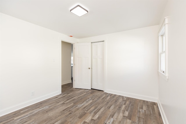 spare room with wood-type flooring