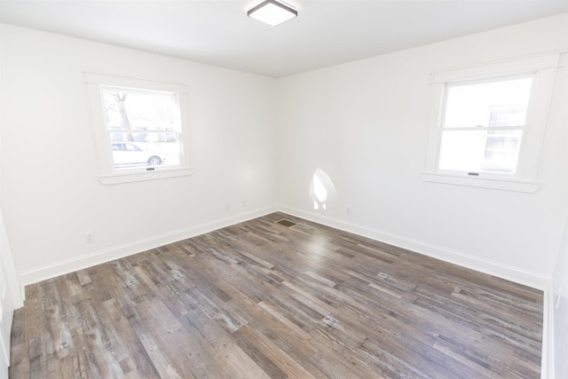 empty room featuring dark wood-type flooring