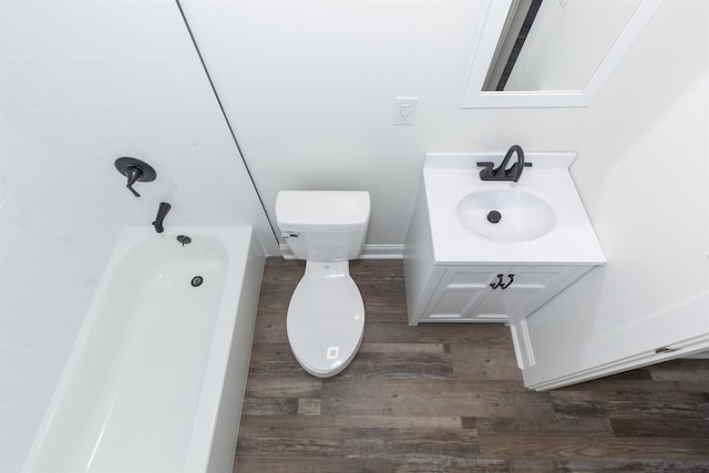 full bathroom with hardwood / wood-style floors, vanity, toilet, and  shower combination