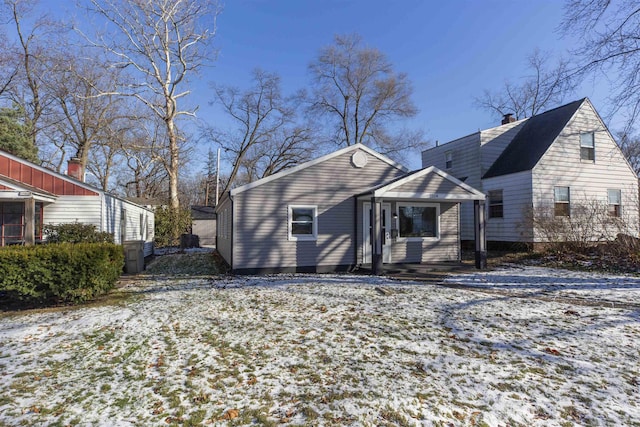 view of snow covered back of property