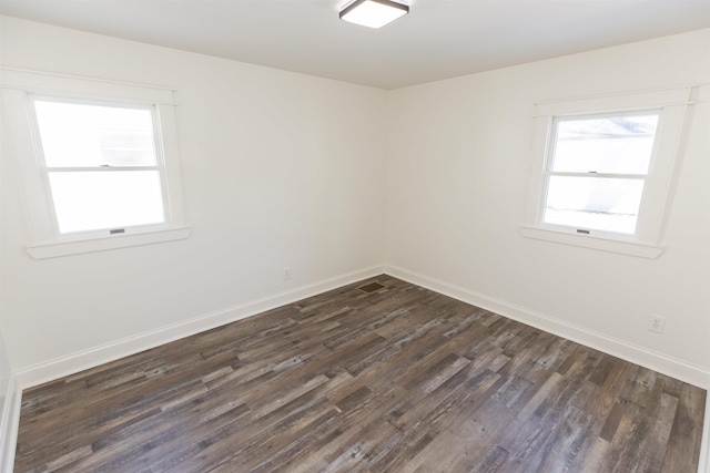 spare room with dark hardwood / wood-style flooring