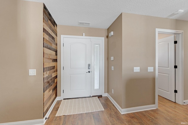 foyer featuring a textured ceiling and light hardwood / wood-style flooring