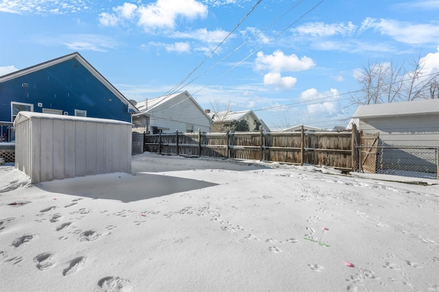 snowy yard featuring an outbuilding