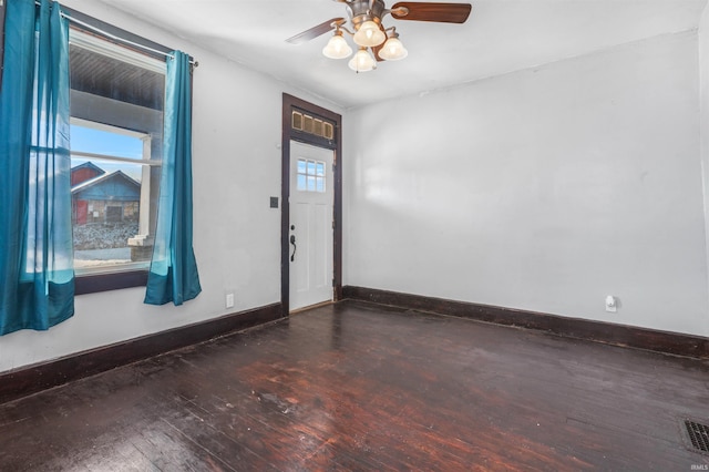 spare room with ceiling fan and dark hardwood / wood-style flooring