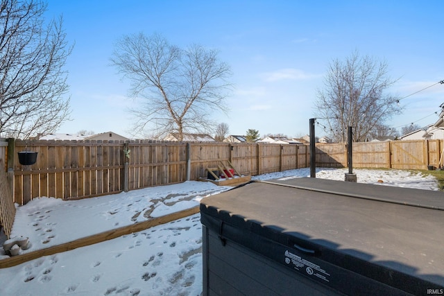 snowy yard with a hot tub