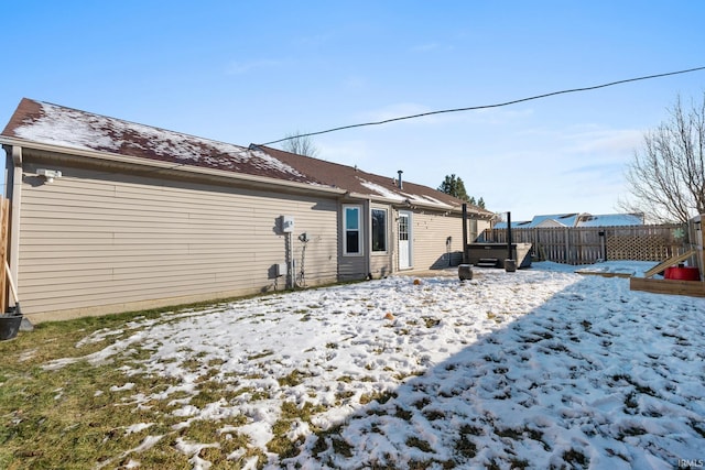 snow covered property featuring a hot tub