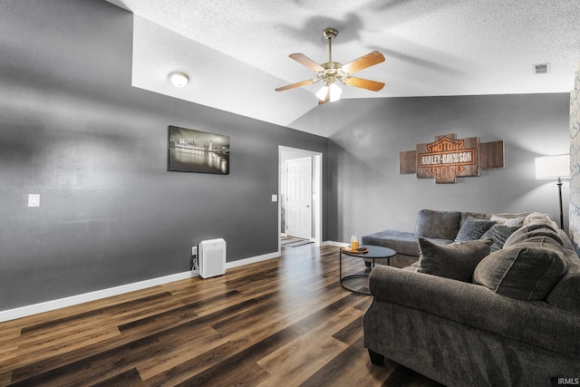 living room with ceiling fan, dark hardwood / wood-style flooring, and vaulted ceiling