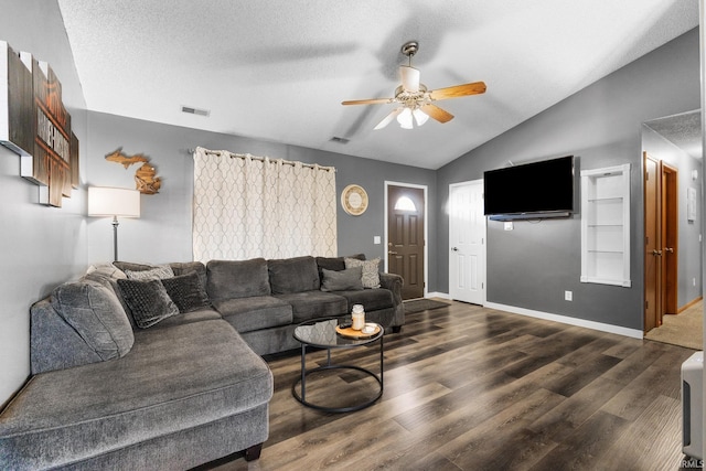 living room featuring ceiling fan, dark hardwood / wood-style flooring, lofted ceiling, and a textured ceiling